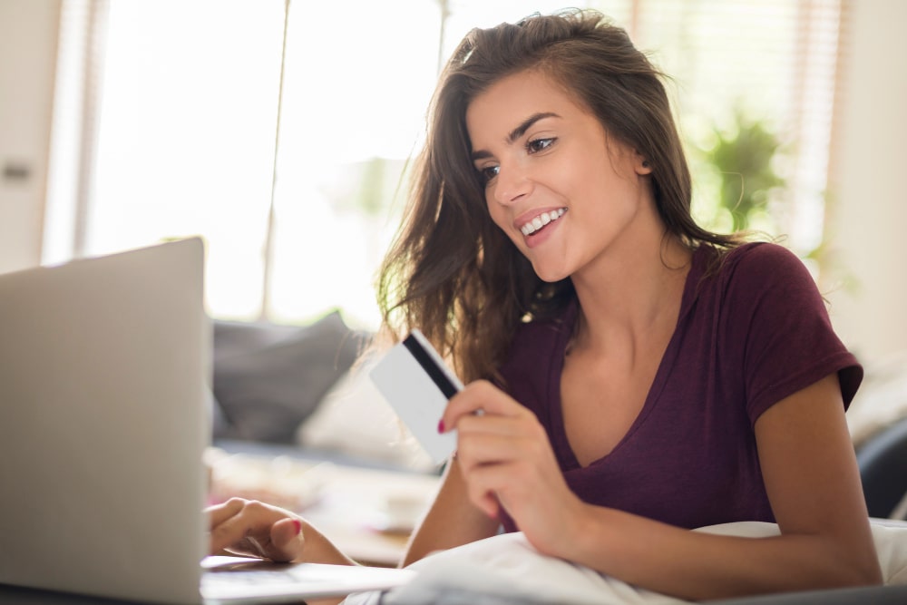 Woman using laptop with coffee